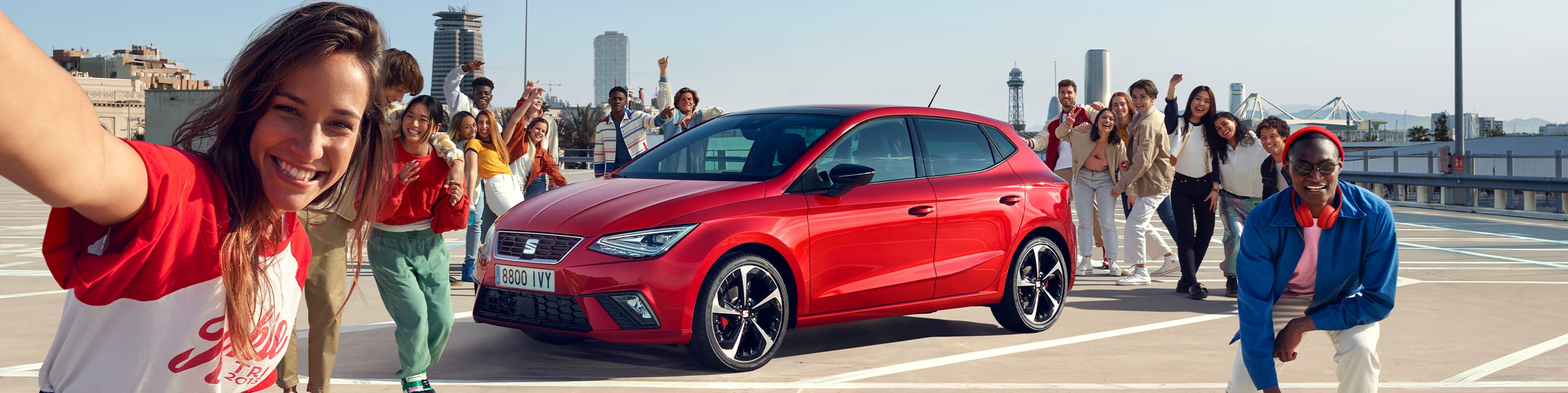 Friends talking next to SEAT Ibiza desire red colour  