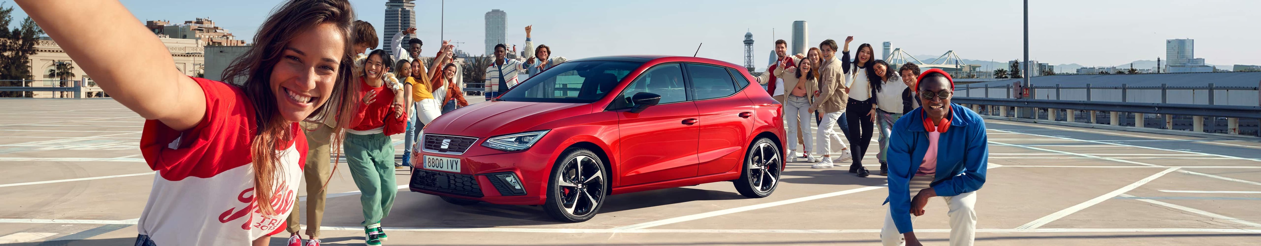 Friends talking next to SEAT Ibiza desire red colour  