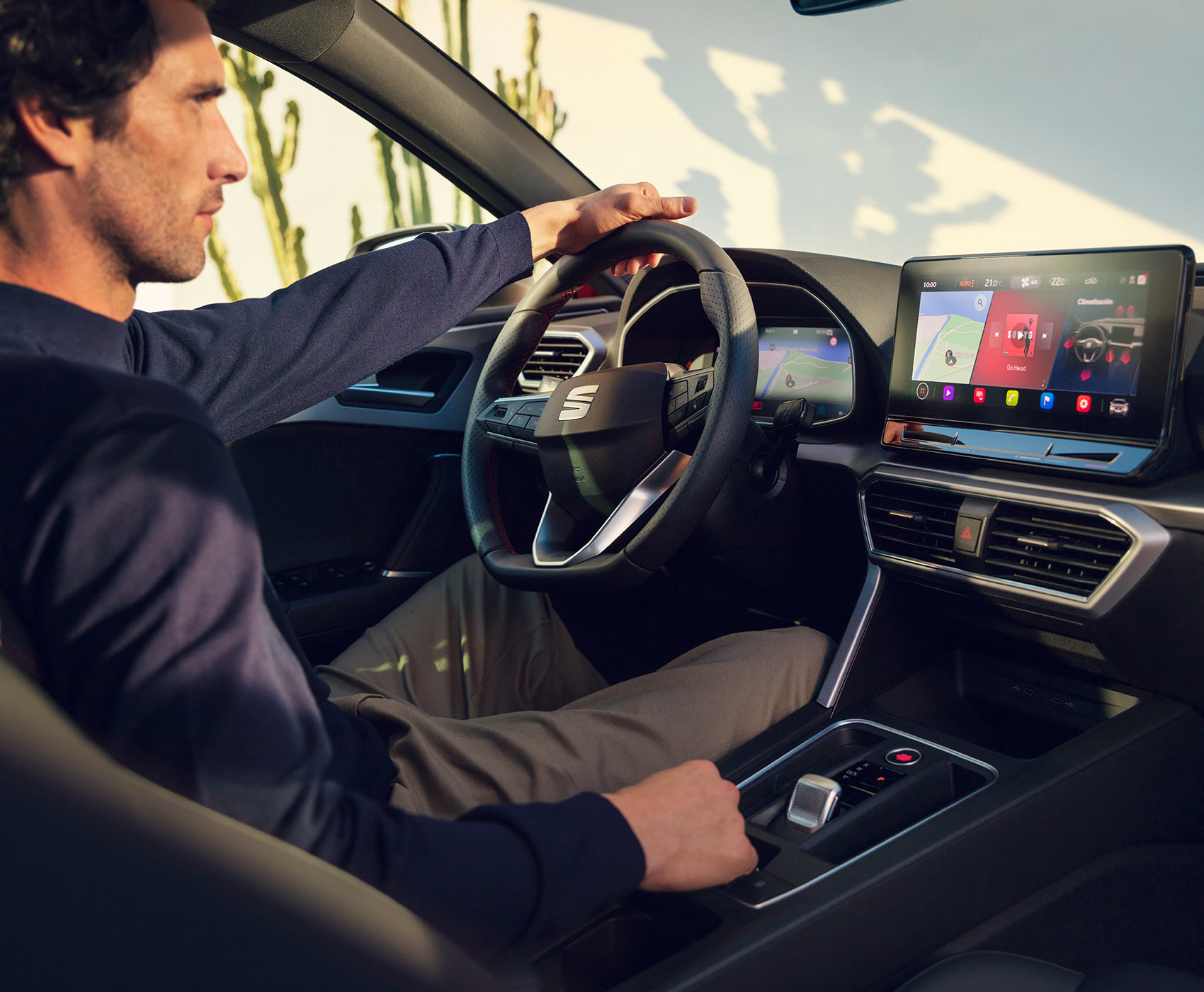 SEAT Leon Sportstourer driver in cockpit charging phone