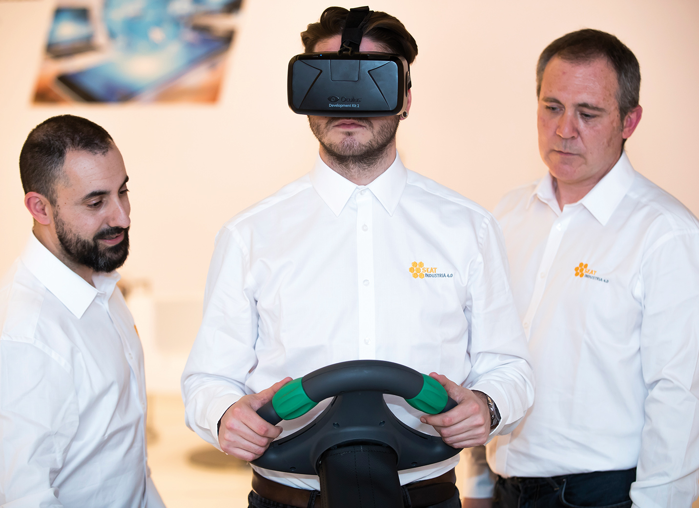 Three SEAT employees training on virtual reality headset and steering wheel