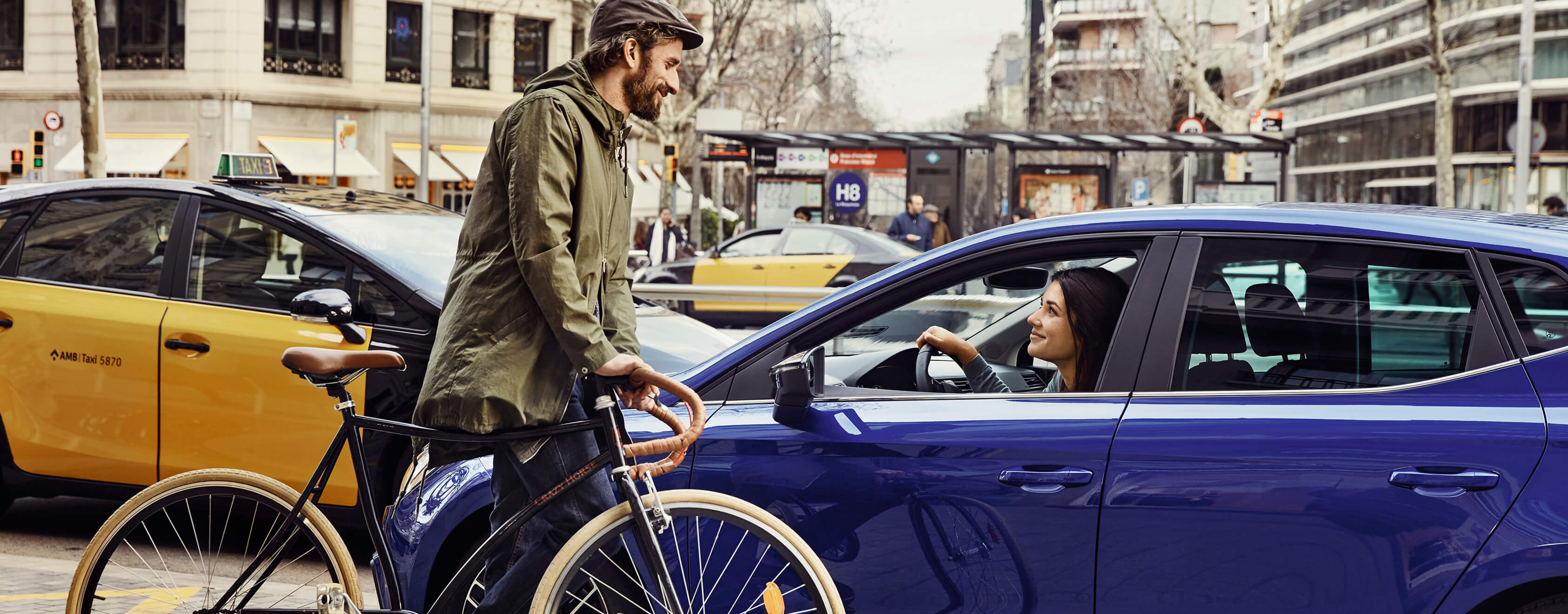 SEAT new car services insurance maintenance – Man on a bicycle in front of a SEAT car