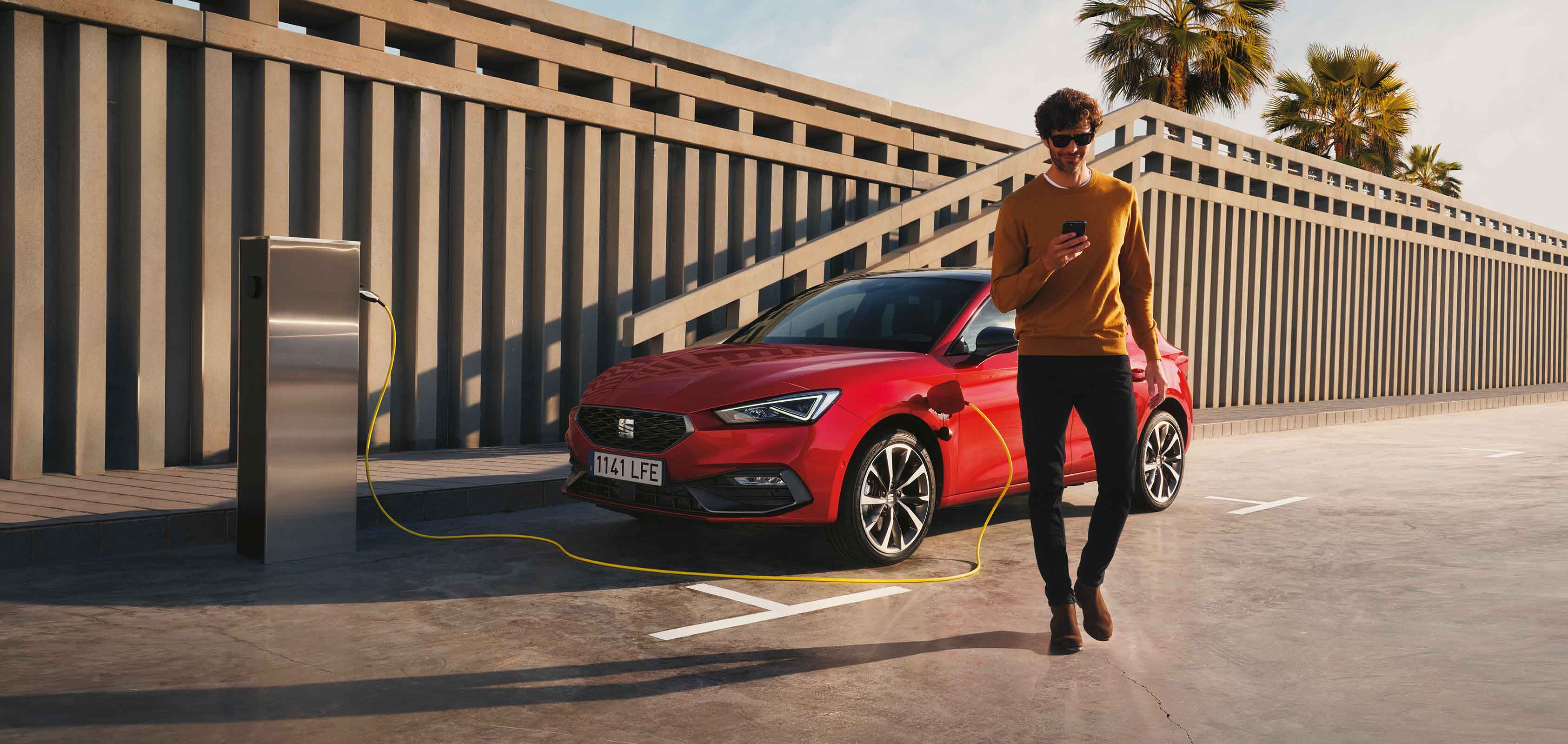 Man checking SEAT CONNECT app outside of the car